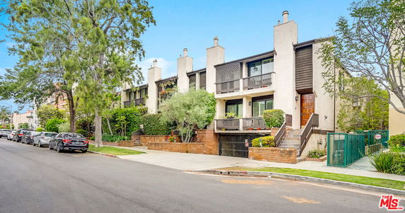 Front view of a multi-story residential building with balconies.