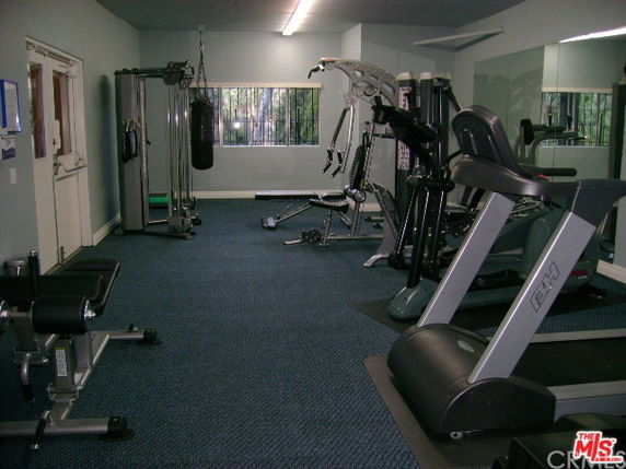 Indoor gym area with various exercise equipment.