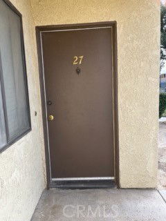 Front view of a door labeled with number 27 in a residential building.