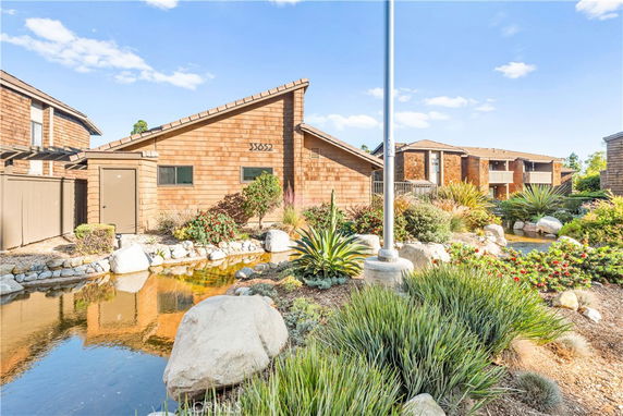 Front view of a house with a sloped roof and wooden exterior.