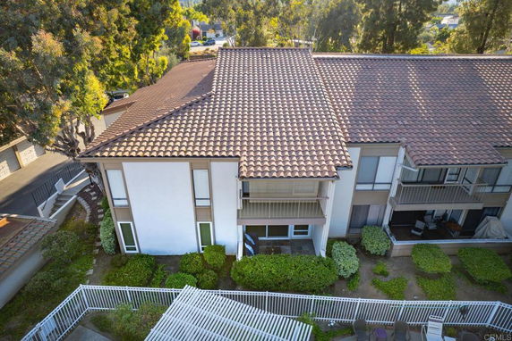 Elevated view of a large building with a tiled roof and multiple balconies.