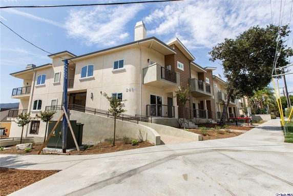 Front view of a multi-story apartment building with balconies.