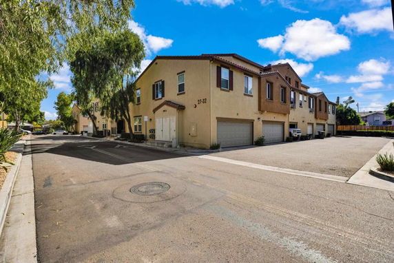 Front view of a two-story residential building with garages.