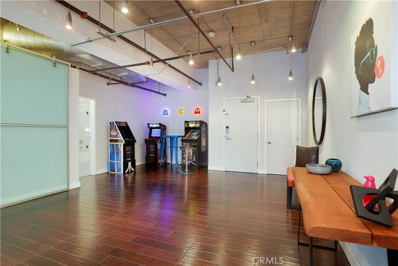 Interior view of a recreational space with arcade machines and modern decor.