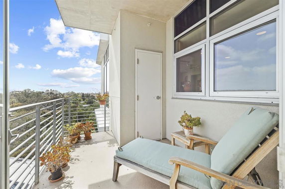 Balcony with outdoor seating and view of surrounding landscape