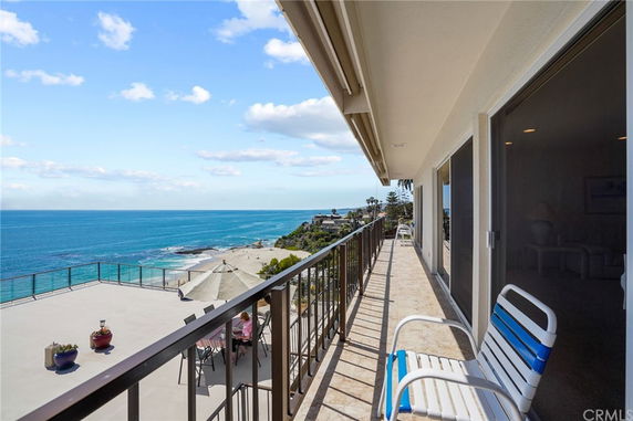 Balcony with an ocean view and seating area.