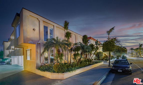 Front view of a multi-story building with modern architectural design and large windows.