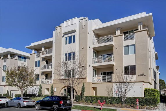 Front view of a multi-story apartment building with balconies.