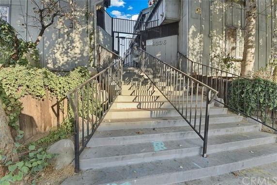 Front view of a building with a staircase leading to the entrance.