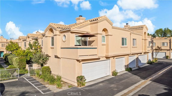 Front view of a two-story townhouse with a double garage.