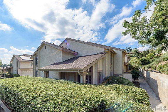 Front view of a two-story house with a sloped roof.
