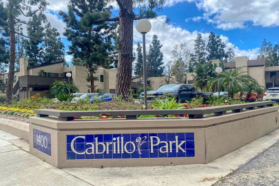 Front view of an apartment complex with multiple buildings and a sign reading 'Cabrillo Park'.