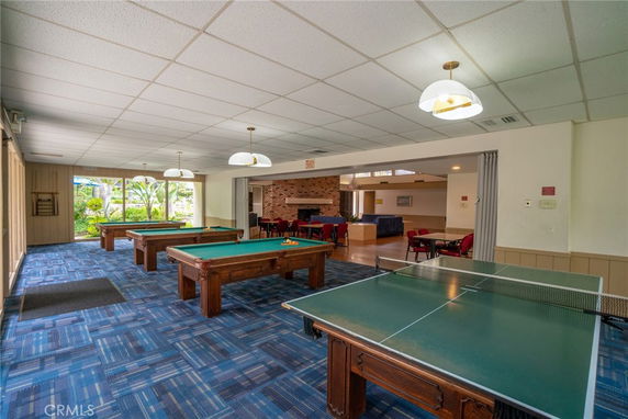 Interior view of a recreation room with billiards tables and a ping pong table.