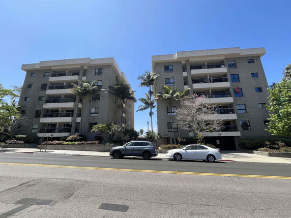 Front view of two five-story apartment buildings with balconies.