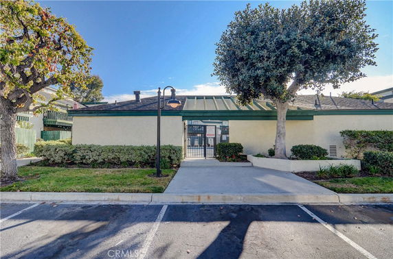 Front view of a single-story building with a green metal roof.