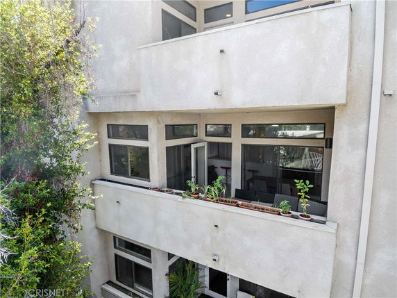 Front view of a multi-story building with balconies and windows.
