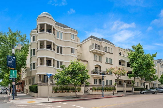 Front view of a multi-story apartment building with balconies.