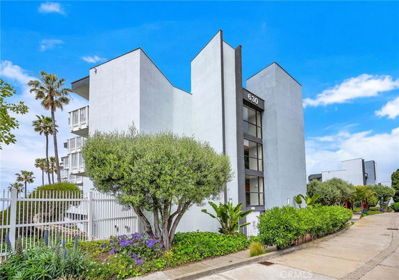 Front view of a modern multi-story building with a minimalist design.