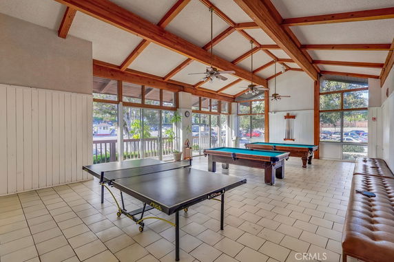Indoor recreational area with table tennis and pool tables.