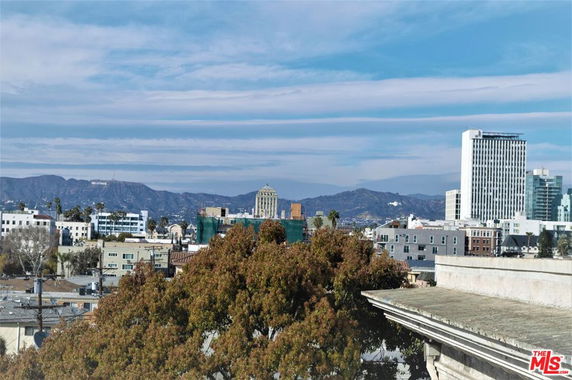 Panoramic view of a cityscape with mountains in the background.
