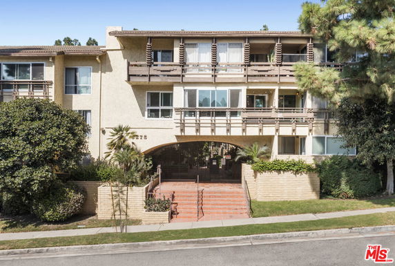 Front view of a multi-story residential building with balconies.