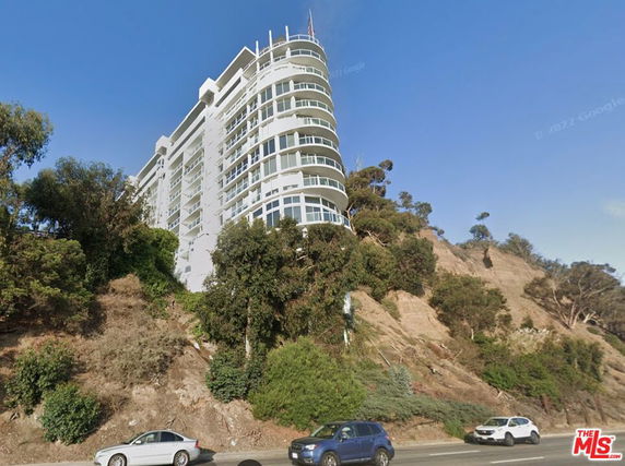 Front view of a multi-story building on a hillside.