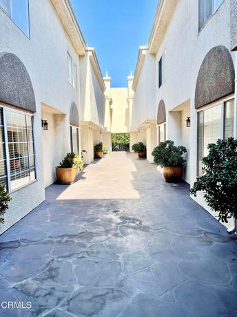 Front view of a multi-story building complex with an entrance pathway.