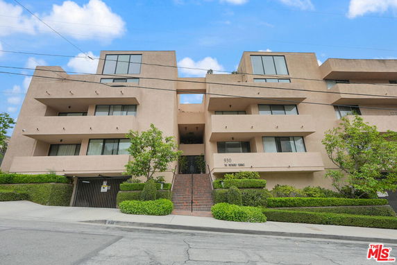 Front view of a multi-story building with balconies.