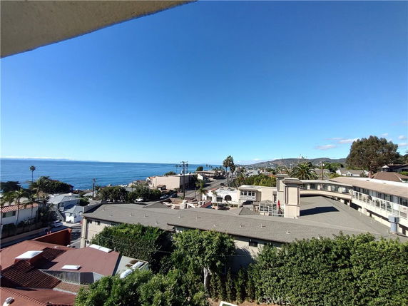 Panoramic view of coastal buildings and ocean.