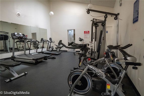 Indoor gym area with exercise equipment including treadmills and stationary bikes.