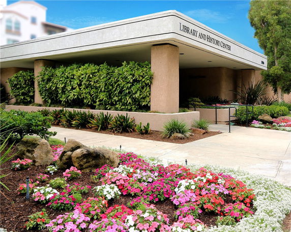 Front view of the Library and History Center building with landscaped gardens.