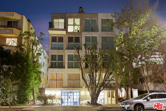 Front view of a multi-story apartment building at night.