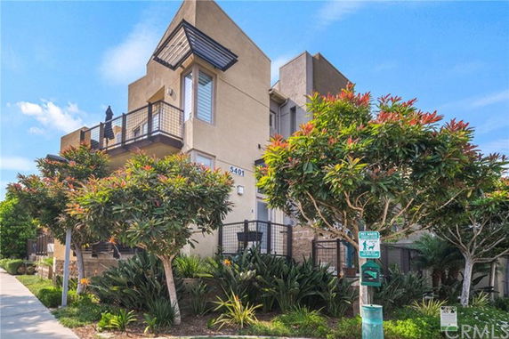 Front view of a multi-story modern building with balconies.