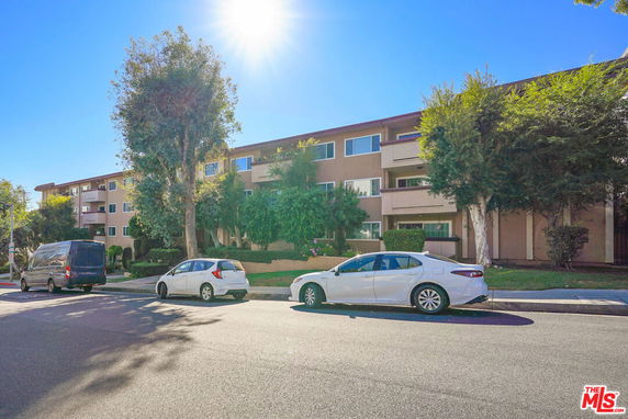 Front view of a multi-story residential building with balconies.