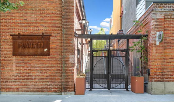 Front view of a brick building with a gated entrance.
