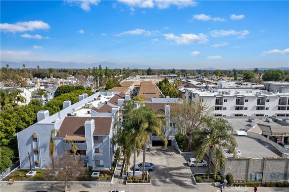 Panoramic view of a residential area with multiple buildings and surrounding greenery.