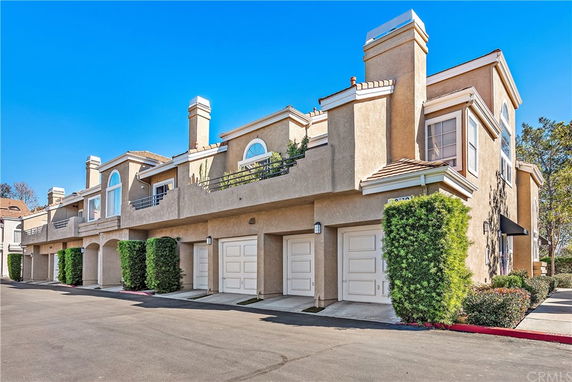 Front view of a two-story townhouse with multiple garages and balconies.