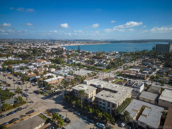 Aerial panoramic view of a residential area near a body of water.
