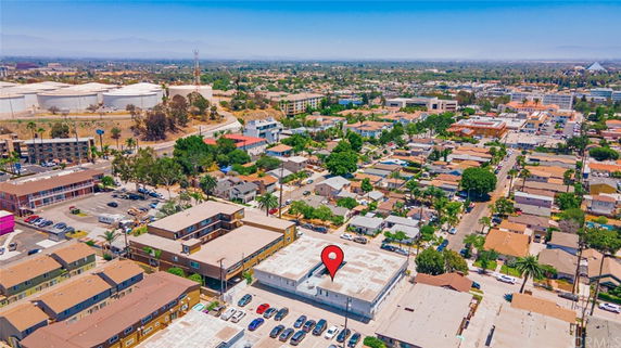 Aerial view of a residential and commercial area with multiple buildings and streets.