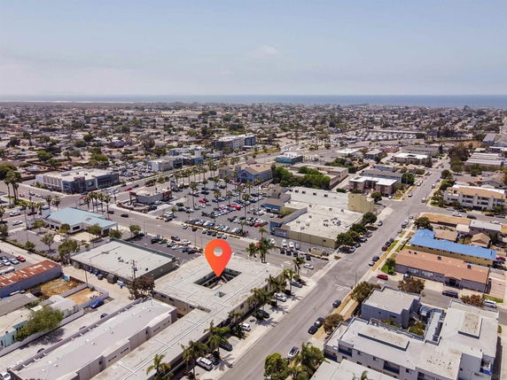 Aerial view of a suburban area with multiple buildings and roads.