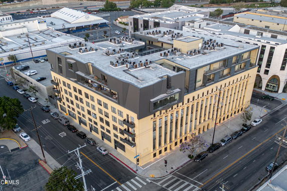 Front view of a multi-story building on a street corner.