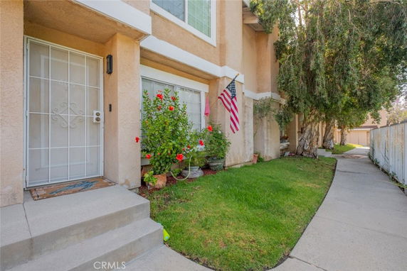 Front view of a house with a pathway, plants, and a patriotic flag.