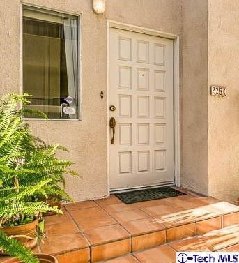 Front view of a house entrance with a white door and a small window.