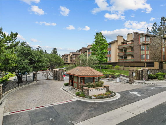 Front view of a multi-story residential building complex with gated entrance.