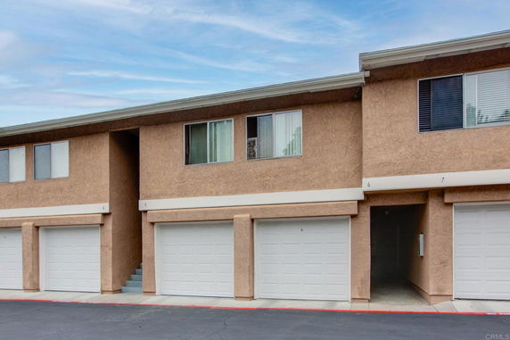 Front view of a two-story building with attached garages.