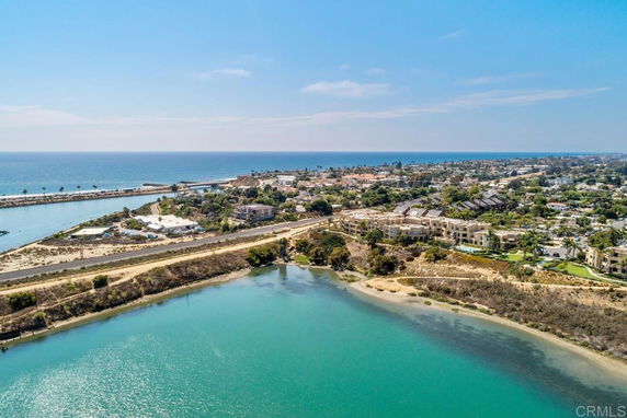 Aerial view of a coastal area with buildings and a body of water.