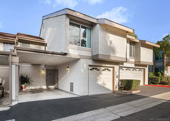 Front view of a two-story townhouse with an attached garage.