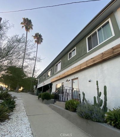 Front view of a two-story building with a slanted driveway.