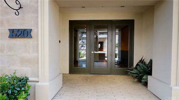 Front view of a building entrance with double doors and address number 520.
