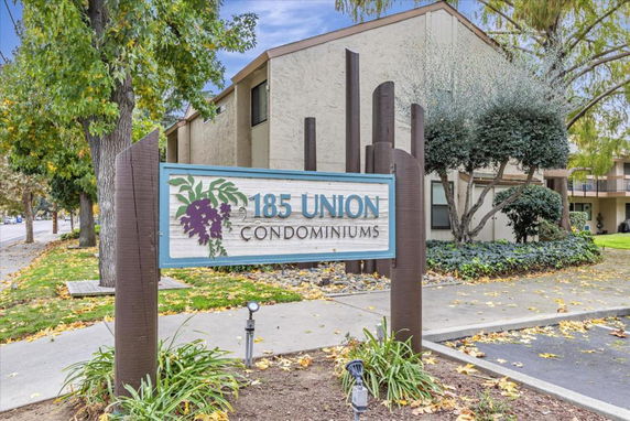 Front view of a condominium building with a sign reading '185 Union Condominiums'.